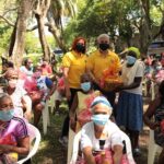 Miguel Angel Cordero y Marisol Henriquez junto a madres con sus canastas.
